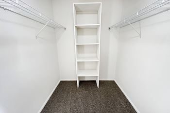 an empty closet in a room with white walls and shelves at Deercross Apartments, Ohio